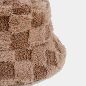 Close-up of the thick brown checkerboard plush texture on this winter bucket hat