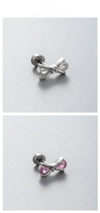 Detail view of titanium steel bow earrings with sparkling clear and pink cubic zirconia