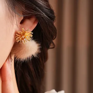 Elegant gold flower earrings with sparkling zircons and beige faux fur pom poms