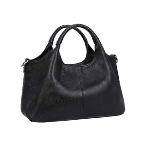 Detail shot of black pebbled leather tote bag with braided handles and metal hardware