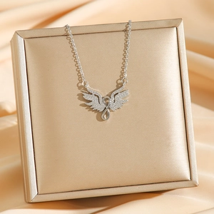 Silver angel wings and infinity symbol necklace with zircons on jewelry box
