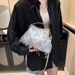 Detail of silver tassel and sequin evening bag with a trapezoidal metal frame