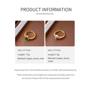 Detail view of vintage gold rings with green and blue oval stones and zircon accents
