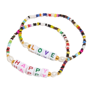 Detail of colorful beads and white acrylic beads with LOVE and HAPPY lettering for bracelet