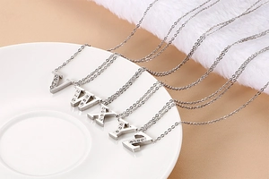 Detail of silver letter pendants V W X Y Z with sparkling crystals on a chain