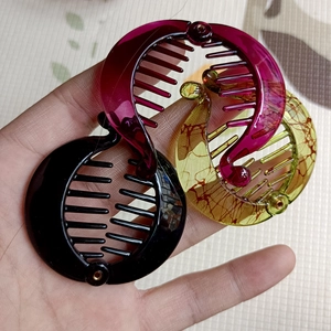 Detailed view of round resin banana clips in black, rose, and amber tortoise patterns