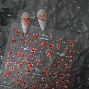 3D Christmas candy nail art stickers with red white patterns on almond nails
