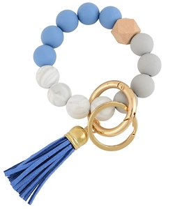 Detail of beaded keychain bracelet with silicone marble beads, wood nut and blue tassel