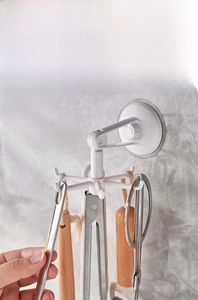 Kitchen wall-mounted rotating storage hook showing 360-degree swivel with six branches