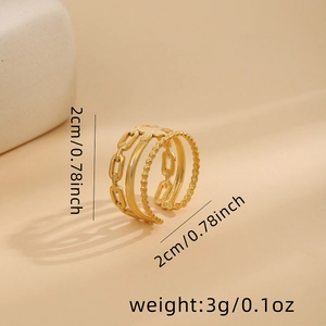 Detailed view of layered gold ring with floral motif and cuban chain design
