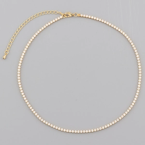 Close-up of gold zircon necklace with sparkling stones and adjustable lobster clasp