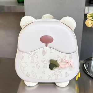 Macro shot of cute bear hardshell backpack with plush ears and pinecone charm detail
