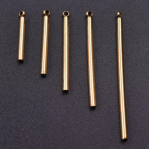 Detailed macro view of five golden stainless steel bar pendants in varying lengths