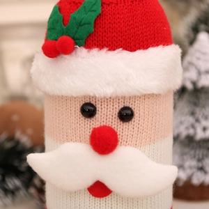 Detailed close-up of knitted Santa wine bottle cover with soft white plush trim details