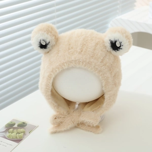 Detail of plush frog earflap hat showing fuzzy texture and cute eye decorations