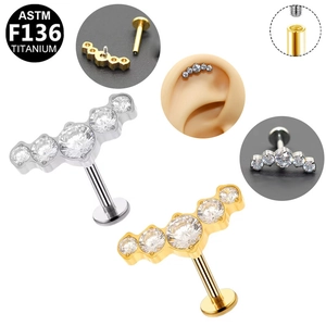 Detail of G23 titanium internallly threaded ear studs with five white curved zircons