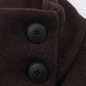 Detail view of dark brown wool coat showing textured fabric and black four-hole buttons