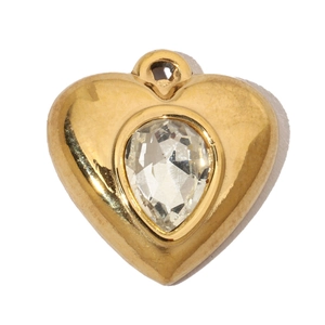 Detail of a golden heart pendant featuring a centered teardrop-shaped clear rhinestone