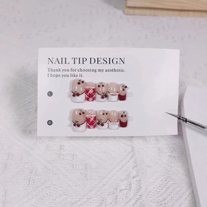 Handmade press-on nails with cute cherry designs, red bows and classic plaid patterns
