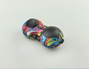 Detailed view of dual-ball stress relief toy featuring vibrant colorful graffiti patterns