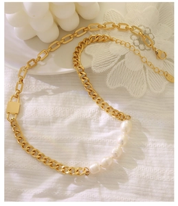 Detail of 18K gold-plated cuban chain necklace with padlock pendant and white pearls