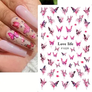 Close-up of pink butterfly nail stickers on long nails with watercolor floral accents