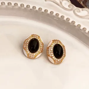 Vintage style oval pearl and flower earrings with black stone and gold plating