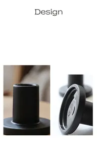 Detail view showing matte black geometric candle holder base with modern design