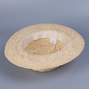Detailed close-up of 100% natural Raffia straw weave and inner beige sweatband detail