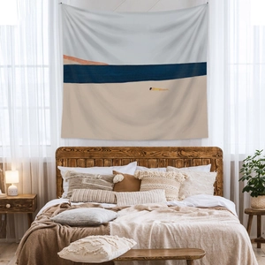 Minimalist beach landscape tapestry hanging over a wooden bed in a cozy bedroom decor