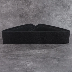 Detailed view of women's black elastic wide waist belt with premium leather trim stitching