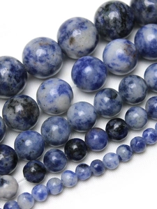 Macro detail of round blue and white sodalite stone beads for DIY jewelry making