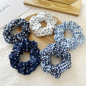 Detailed set of 5 patterned fabric scrunchies in floral, polka dot, and plaid designs