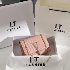 Pink chevron quilted shoulder bag with gold V buckle and tassel in gift packaging