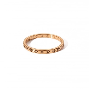 Macro detail of rose gold stainless steel ring featuring hollow flower patterns
