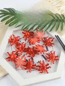 Macro shot of realistic PVC mini octopus figurines in a decorative white hex tray