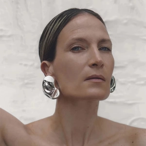 Dramatic oversized silver sculptural geometric stud earrings with a high-polished finish