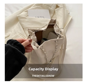 Detailed top view of the cream bucket bag interior showing spacious capacity and drawstring