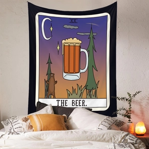 Detail of Bohemian tarot tapestry featuring a beer mug and bear design on a white brick wall