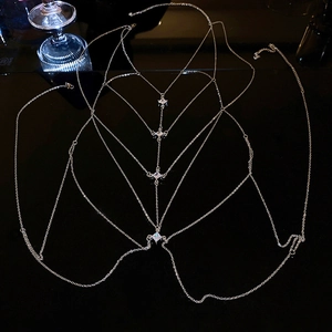 Close-up of multilayer silver body chain with four square zircons on reflective background