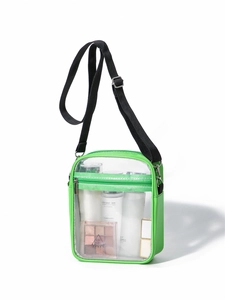 Detail view of transparent green PVC crossbody bag with makeup and adjustable strap
