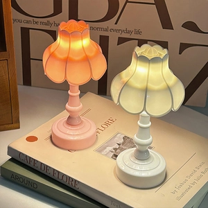 Mini lily of the valley night lights in pink and white set on books for cozy room decor