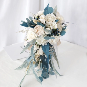 Elegant cascading bridal bouquet with white roses, blue berries and eucalyptus leaves