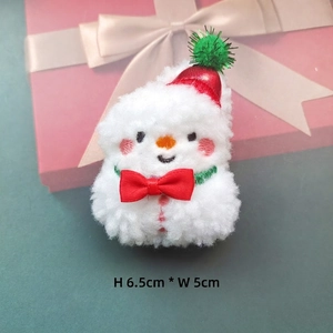 Close-up of a plush snowman charm with red hat and scarf, measuring H 6.5cm x W 5cm