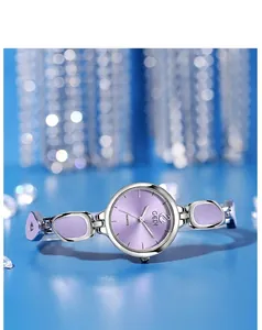 Detail of elegant quartz watch with purple sunburst dial and silver metal strap