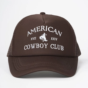Detail of white American Cowboy Club embroidery on dark brown mesh trucker hat