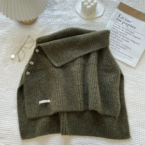 Army green knitted shawl wrap with turtleneck and decorative side buttons on white fabric