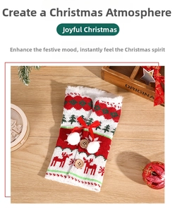 Close-up of a knitted Christmas wine bottle cover with reindeer patterns and pom-poms