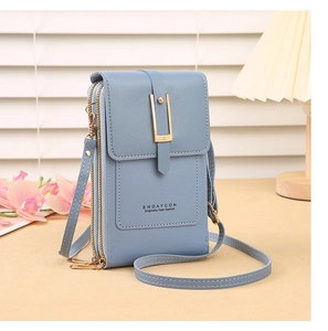 Close-up of matte grey-blue crossbody phone bag with three zippered compartments