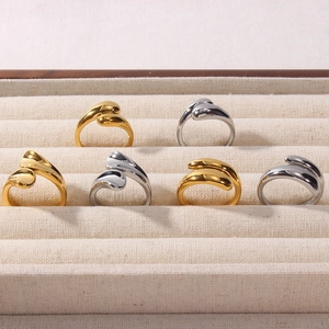 Detail of teardrop geometric 18K gold and silver plated rings on a jewelry tray